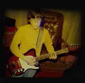 Lenny with guitar at a young age
